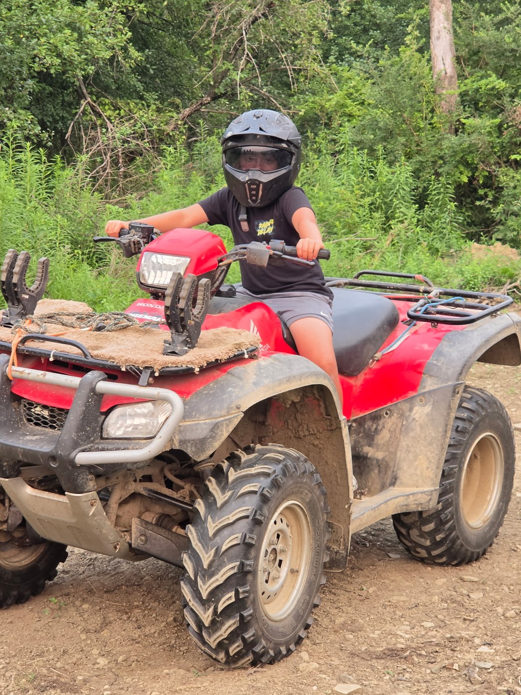 Owen with his helmet on the four-wheeler