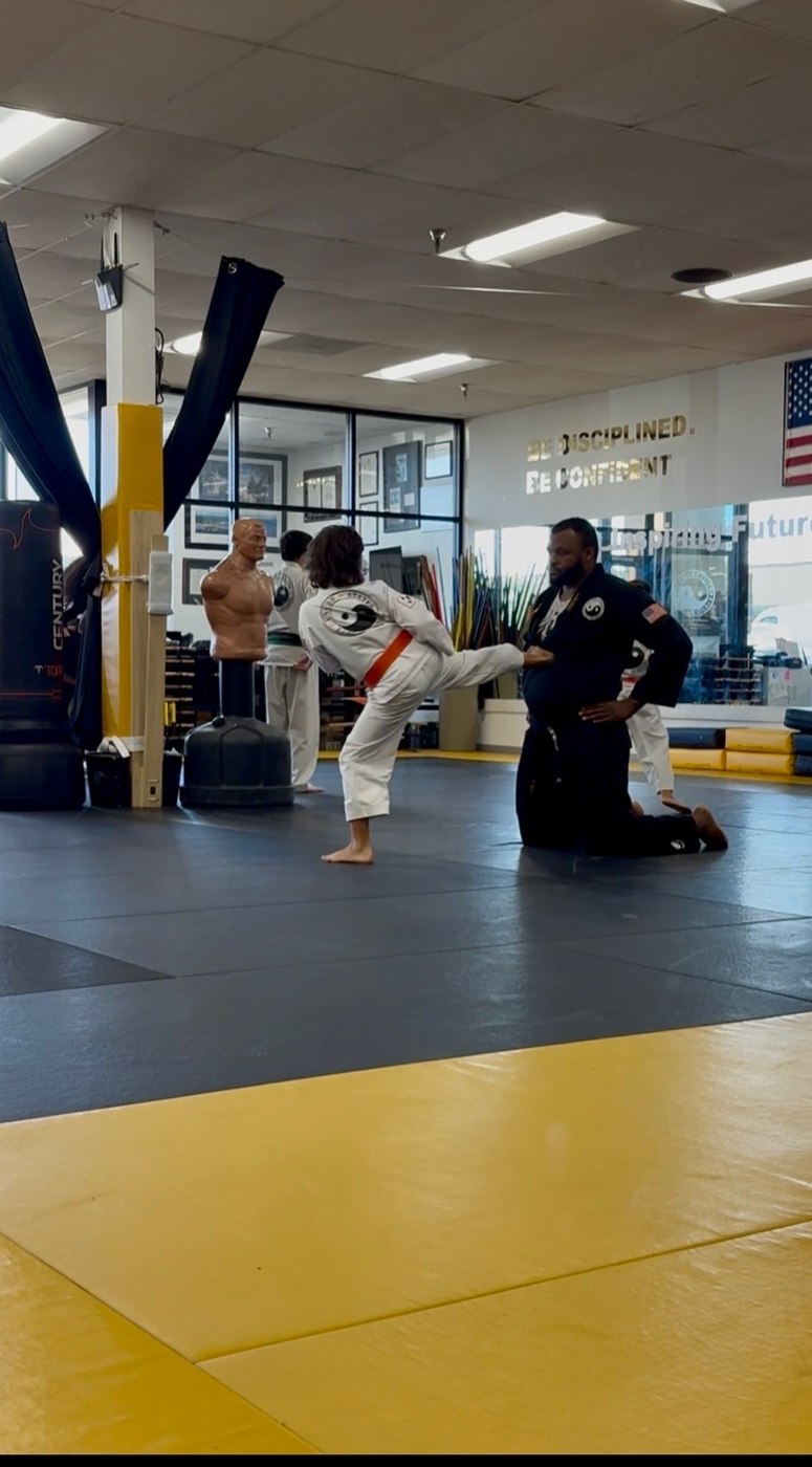 Owen throwing a high kick at karate practice